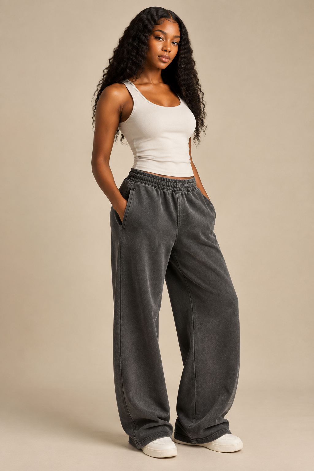 Black female model wearing dark-gray vintage-wash ruched wide-leg sweatpants in a studio setting